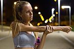 Beautiful Girl Doing Stretching At Night Stock Photo