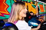 Beautiful Girl In An Electric Bumper Car At Amusement Park Stock Photo