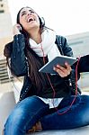 Beautiful Girl Listening To Music In City Stock Photo