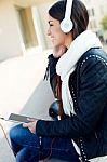 Beautiful Girl Listening To Music In City Stock Photo