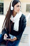 Beautiful Girl Listening To Music In City Stock Photo