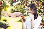 Beautiful Girl Reading Text Message On Her Smart Phone In The Ga Stock Photo