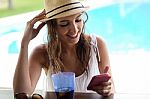 Beautiful Girl Taking A Mobile Phone At The Swimming Pool Stock Photo