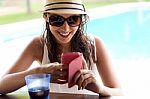 Beautiful Girl Taking A Mobile Phone At The Swimming Pool Stock Photo