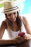 Beautiful Girl Taking A Mobile Phone At The Swimming Pool Stock Photo