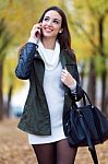 Beautiful Girl Talking On Phone In Autumn Stock Photo