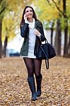 Beautiful Girl Talking On Phone In Autumn Stock Photo