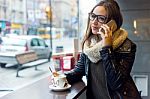 Beautiful Girl Using Her Mobile Phone In Cafe Stock Photo