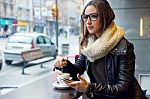 Beautiful Girl Using Her Mobile Phone In Cafe Stock Photo