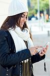 Beautiful Girl Using Her Mobile Phone In City Stock Photo