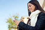 Beautiful Girl Using Her Mobile Phone In City Stock Photo