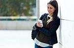 Beautiful Girl Using Her Mobile Phone In City Stock Photo