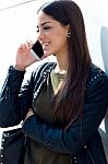 Beautiful Girl Using Her Mobile Phone In City Stock Photo