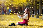 Beautiful Girl With Yellow Leaves In Nami Island, Korea. Nami Island In Autumn Stock Photo