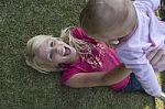 Beautiful Mother Playing With Her Newborn Baby Stock Photo