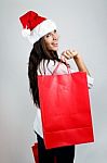 Beautiful Santa Girl  Carrying Red Shopping Bags Stock Photo