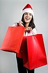 Beautiful Santa Girl  Carrying Red Shopping Bags Stock Photo