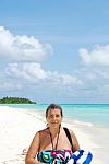 Beautiful Senior Woman Walking On A Tropical Beach Stock Photo