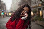 Beautiful Smiling Woman In Red Coat With Mobile Phone In Hands, Stock Photo