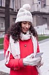 Beautiful Woman In Red Coat And Wool Cap And Gloves With Smartph Stock Photo