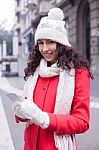 Beautiful Woman In Red Coat And Wool Cap And Gloves With Smartph Stock Photo