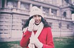 Beautiful Woman In Red Coat And Wool Cap And Gloves With Smartph Stock Photo