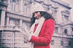 Beautiful Woman In Red Coat And Wool Cap And Gloves With Smartph Stock Photo