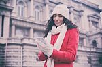 Beautiful Woman In Red Coat And Wool Cap And Gloves With Smartph Stock Photo