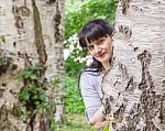 Beautiful Woman Looking Out Because Of A Birch Stock Photo