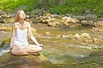 Beautiful Woman Practive Yoga On River In Nature Stock Photo