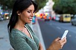 Beautiful Woman Use Her Phone In The City At Night Stock Photo