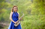 Beautiful Woman Wear Blue Evening Dress Holding Saxophone Stand Stock Photo