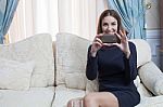 Beautiful Woman With Blue Eyes Photo With Smart Phone In The Living Room Stock Photo