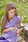 Beautiful Woman With Tablet Computer In Park Stock Photo