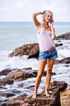 Beautiful Young Blonde Woman Posing Outdoor At The Rocky Sea Sho Stock Photo