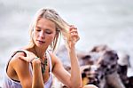 Beautiful Young Blonde Woman Posing Outdoor At The Rocky Sea Sho Stock Photo