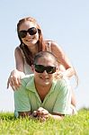 Beautiful Young Couple Lie Down On Grass Stock Photo