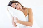 Beautiful Young Woman Holding A Pillow And Slepping On Bed Stock Photo