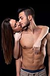 Beautiful Young Woman Kissing Handsome Man Stock Photo