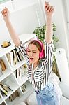 Beautiful Young Woman Listening To Music At Home Stock Photo