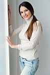 Beautiful Young Woman Looking At Camera At Home Stock Photo