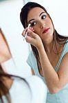 Beautiful Young Woman Making Make-up Near Mirror Stock Photo