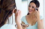 Beautiful Young Woman Making Make-up Near Mirror Stock Photo