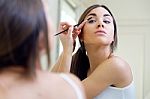 Beautiful Young Woman Making Make-up Near Mirror Stock Photo