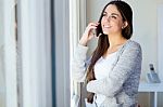 Beautiful Young Woman Talking On The Phone At Home Stock Photo