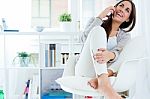 Beautiful Young Woman Talking On The Phone At Home Stock Photo