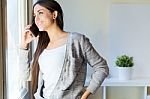 Beautiful Young Woman Talking On The Phone At Home Stock Photo