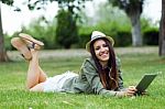 Beautiful Young Woman Using Digital Tablet In The Park Stock Photo