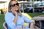 Beautiful Young Woman Using Her Mobile Phone In A Restaurant Ter Stock Photo