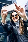 Beautiful Young Woman Using Her Mobile Phone In The Car Stock Photo